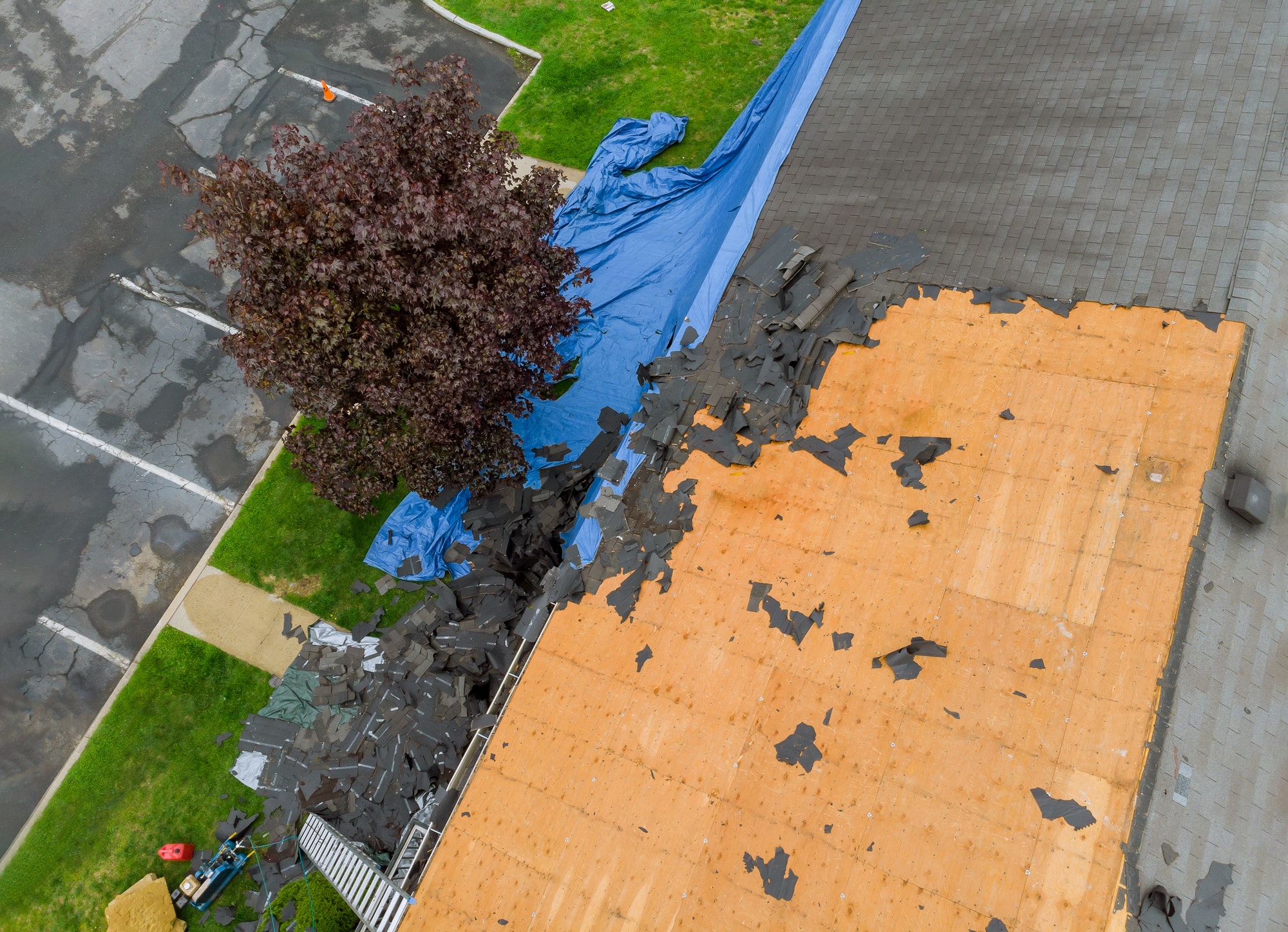 Construction worker on renovation roof the house installed new shingles