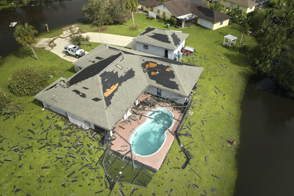 Hurricane Ian destroyed house roof in Florida residential area.